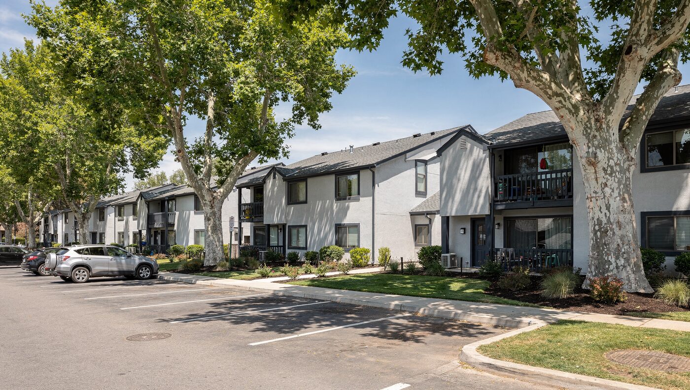 Sycamore Park Apartments, renovated three-story garden apartment buildings with new siding and a pool