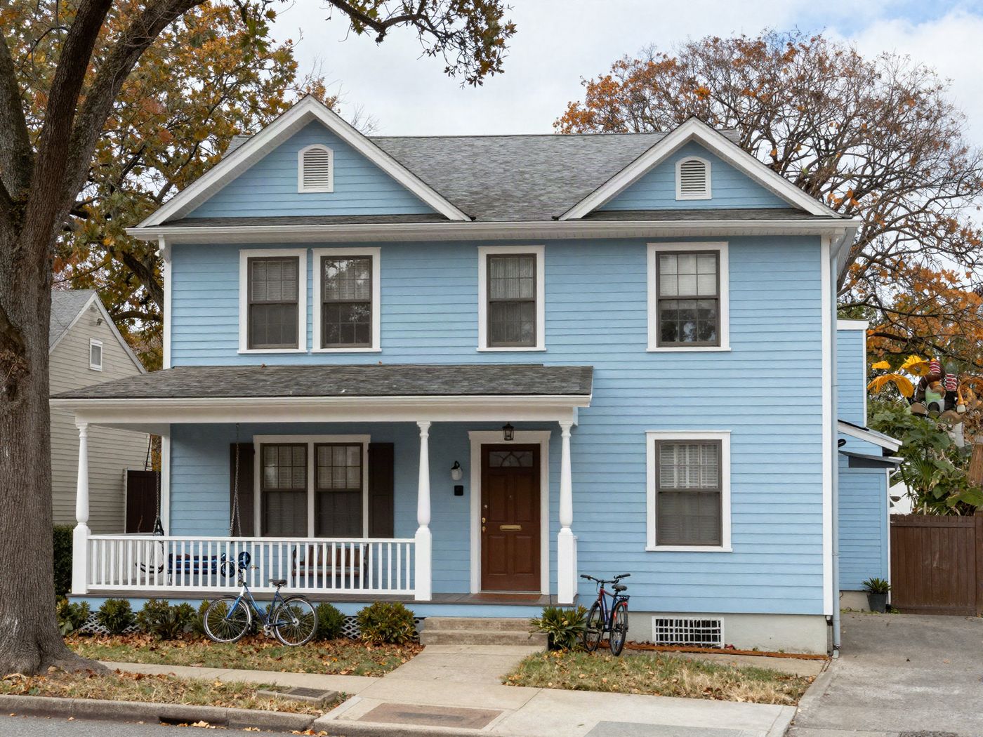 A two-story house near a college campus with a wide front porch